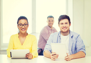 Image showing smiling team with tablet pc computers at office