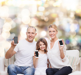 Image showing happy family with smartphones