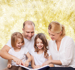 Image showing happy family with book at home