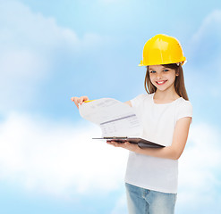 Image showing smiling little girl in hardhat with clipboard