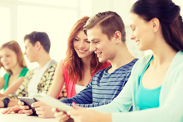 Image showing smiling students with tablet pc at school