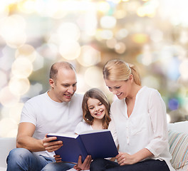 Image showing happy family with book at home