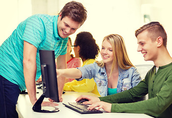 Image showing smiling students in computer class at school