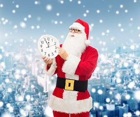 Image showing man in costume of santa claus with clock