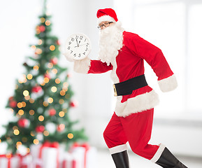 Image showing man in costume of santa claus with clock