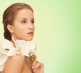 Image showing beautiful young woman with orchid flowers