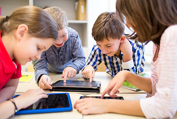 Image showing group of school kids with tablet pc in classroom