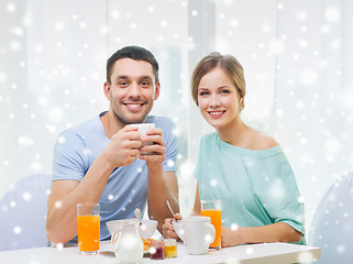 Image showing smiling couple having breakfast at home