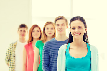 Image showing smiling students with teenage girl in front