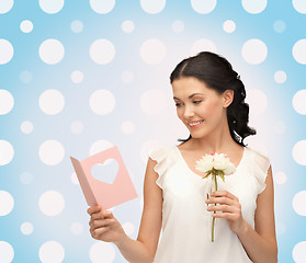 Image showing smiling young woman with flower