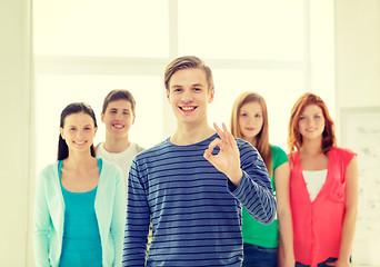 Image showing students with teenager in front showing ok sign