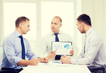 Image showing serious businessmen with papers in office