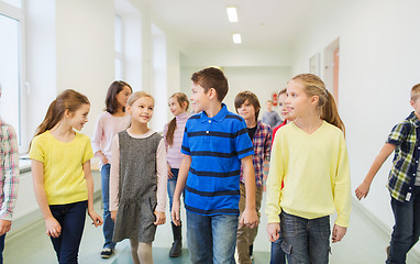 Image showing group of smiling school kids walking in corridor