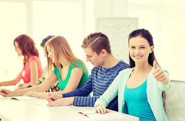 Image showing smiling students with textbooks at school