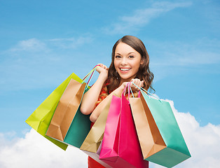 Image showing smiling woman with colorful shopping bags