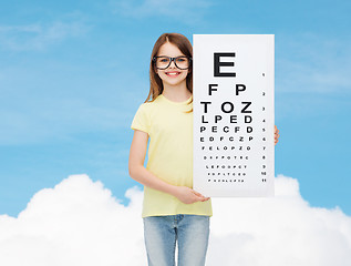 Image showing little girl in eyeglasses with eye checking chart