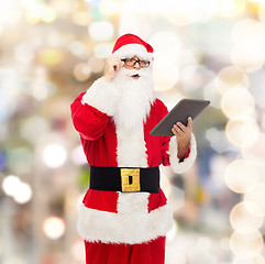 Image showing man in costume of santa claus with tablet pc