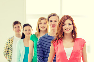 Image showing smiling students with teenage girl in front