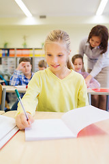 Image showing group of school kids writing test in classroom