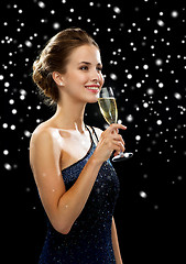 Image showing smiling woman holding glass of sparkling wine