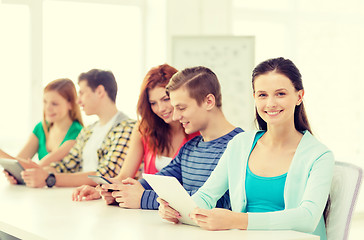 Image showing smiling students with tablet pc at school