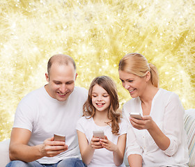 Image showing happy family with smartphones