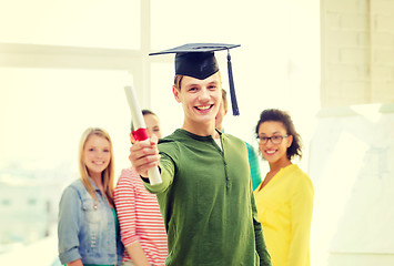 Image showing smiling male student with diploma and corner-cap