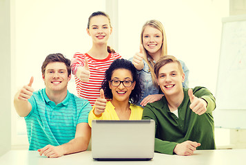 Image showing smiling students with laptop at school