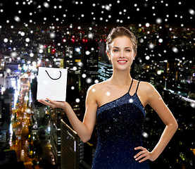 Image showing smiling woman with white blank shopping bag