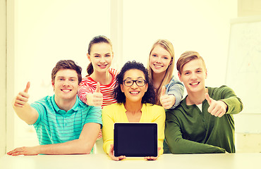 Image showing smiling students showing tablet pc blank screen