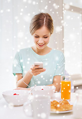 Image showing smiling woman with smartphones having breakfast