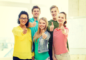 Image showing five smiling showing thumbs up at school