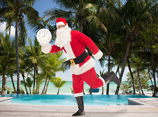 Image showing man in costume of santa claus with clock