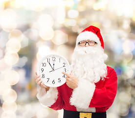 Image showing man in costume of santa claus with clock