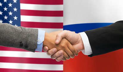 Image showing handshake over american and russian flags