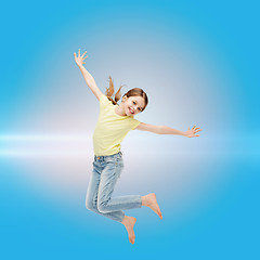 Image showing smiling little girl jumping