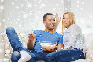 Image showing smiling couple watching tv at home