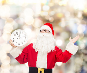 Image showing man in costume of santa claus with clock