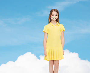 Image showing smiling little girl in yellow dress