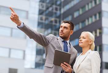 Image showing serious businessmen with tablet pc outdoors