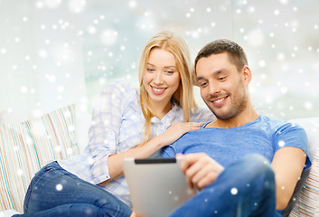 Image showing smiling happy couple with tablet pc at home