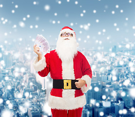 Image showing man in costume of santa claus with euro money