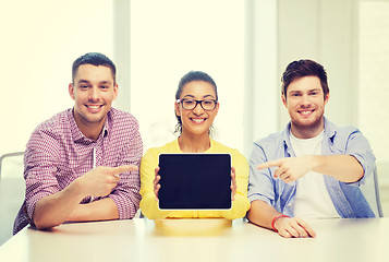 Image showing smiling colleagues showing tablet pc blank screen