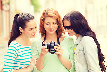 Image showing smiling teenage girls with camera