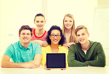 Image showing smiling students showing tablet pc blank screen