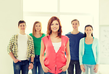 Image showing smiling students with teenage girl in front