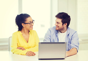 Image showing two smiling people with laptop in office