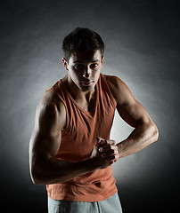 Image showing young man showing biceps