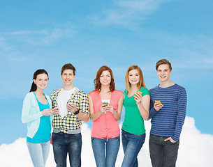 Image showing smiling students with smartphones