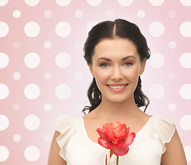 Image showing smiling young woman with flower